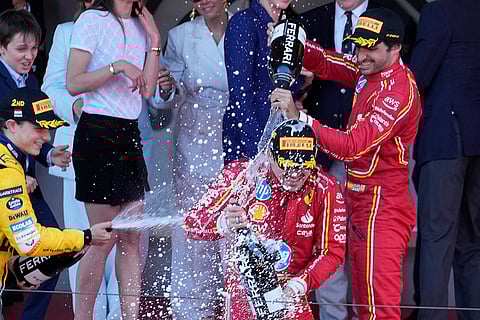 Charles Leclerc celebrates with Oscar Piastri and Carlos Sainz